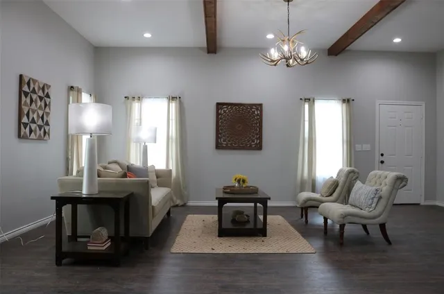 a living room with furniture and a chandelier