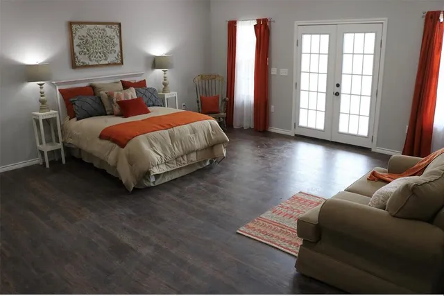 a bed sitting in a bedroom next to a window