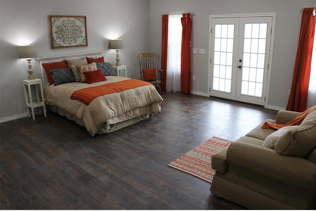 119 Dove Street Boyd, TX 76023 - Photo 7 of 18 a bed sitting in a bedroom next to a window