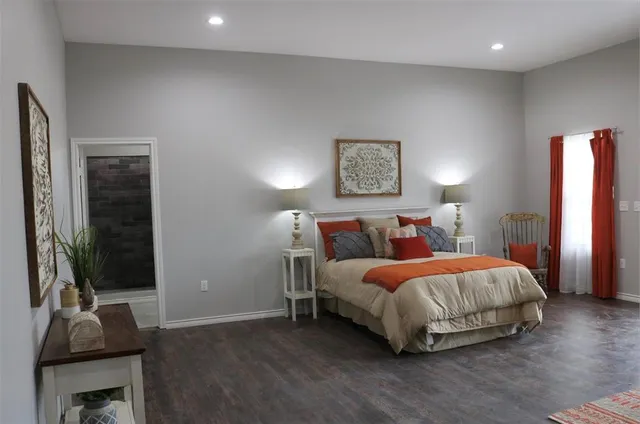 a bedroom with a bed and a flat screen tv