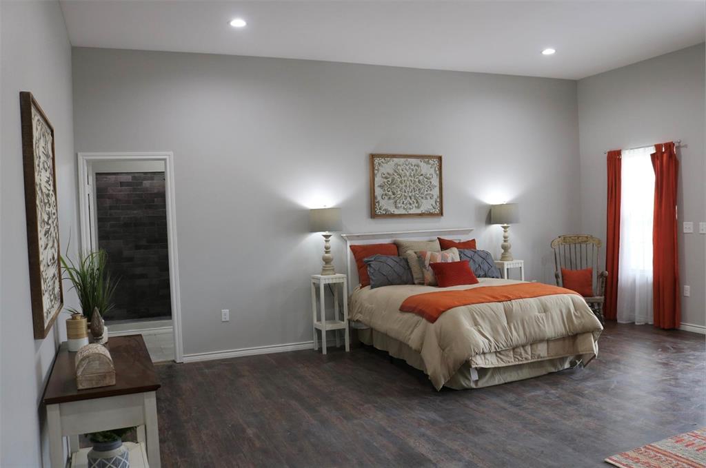 119 Dove Street Boyd, TX 76023 - Photo 8 of 18 a bedroom with a bed and a flat screen tv