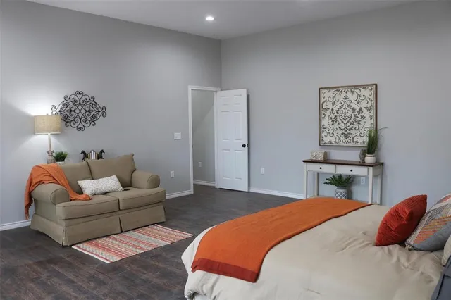 a bedroom with a bed and a couch