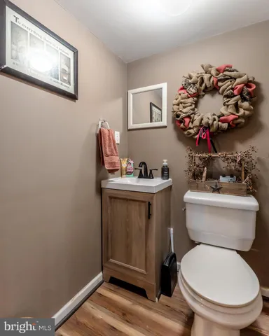 a bathroom with a toilet a sink and a mirror