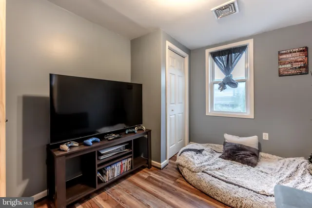 a bedroom with furniture and a flat screen tv