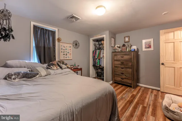 a bedroom with a bed and a dresser