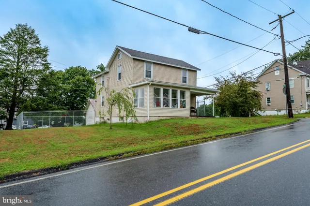 a view of a house with a yard and tree s
