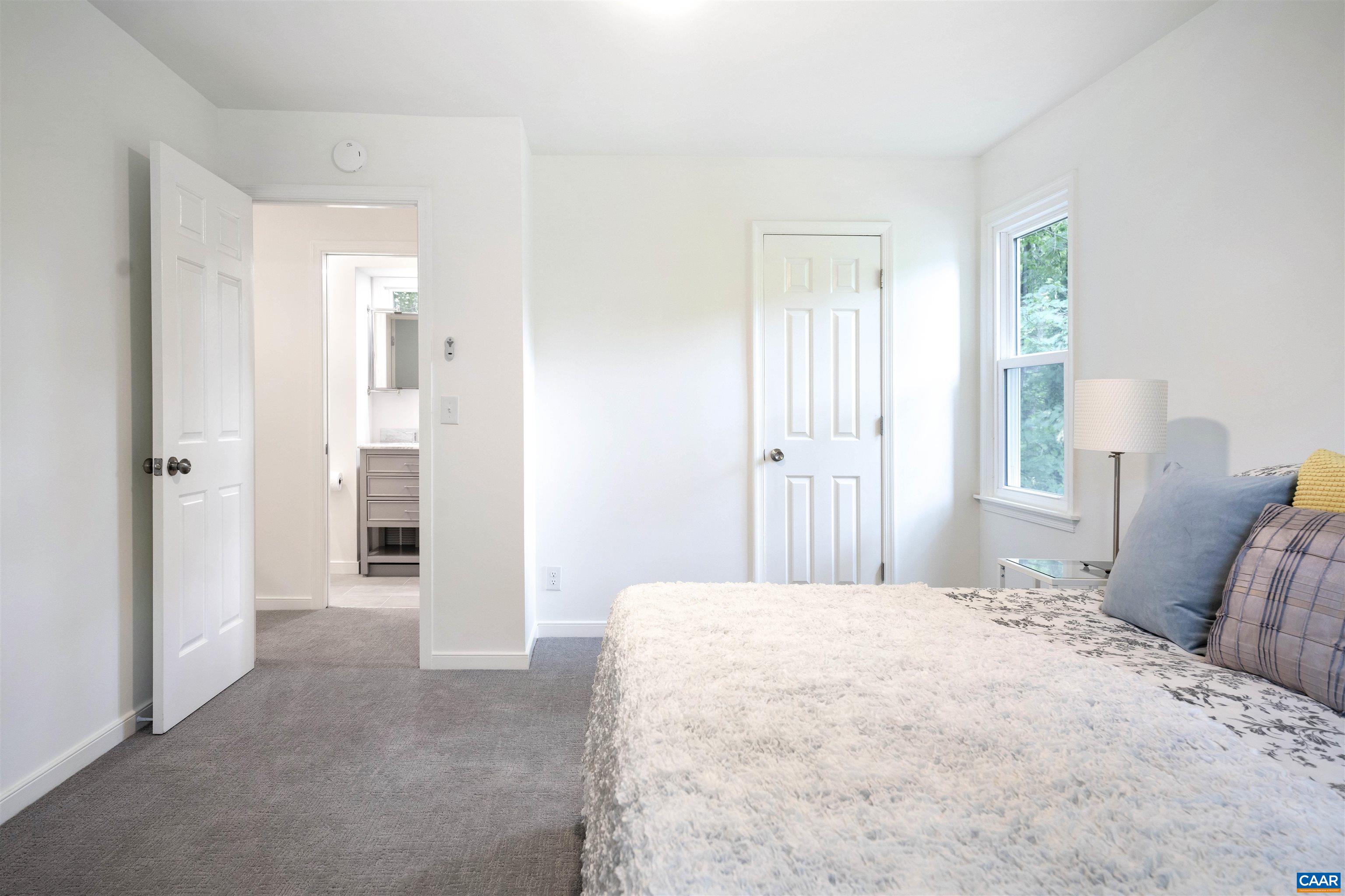 1410 Westwood Road Charlottesville, VA 22903 - Photo 13 of 20 a bedroom with a bed and a refrigerator