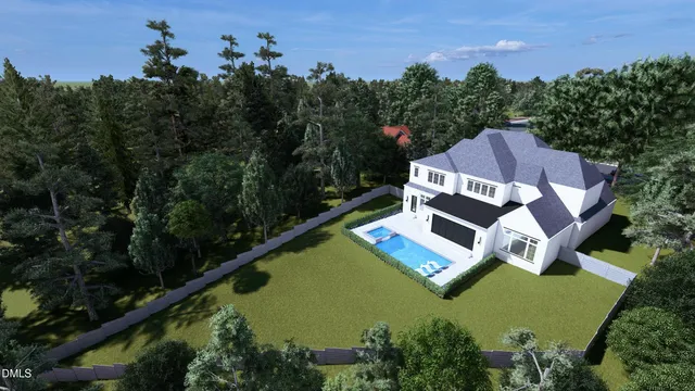 an aerial view of a house with garden space and trees all around
