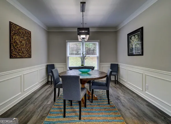 a view of a dining room with furniture window and wooden floor