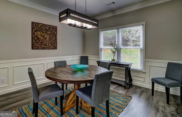a view of a dining room with furniture window and wooden floor