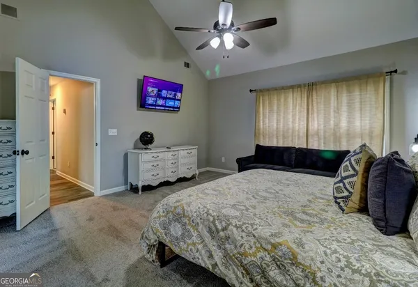 a spacious bedroom with a bed and a walk in closet