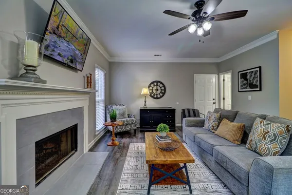 a living room with furniture a fireplace and a window