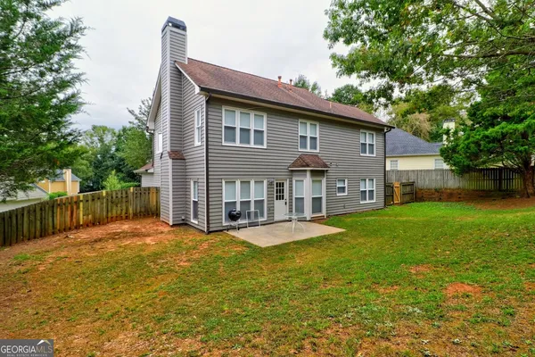 a view of a house with a yard patio and deck