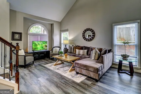 a living room with furniture and a wooden floor
