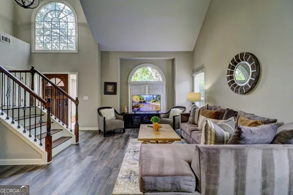a living room with furniture and a clock