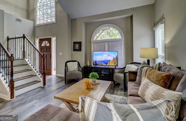 a living room with furniture a rug and a flat screen tv