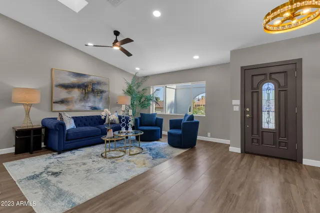 a living room with furniture and a potted plant
