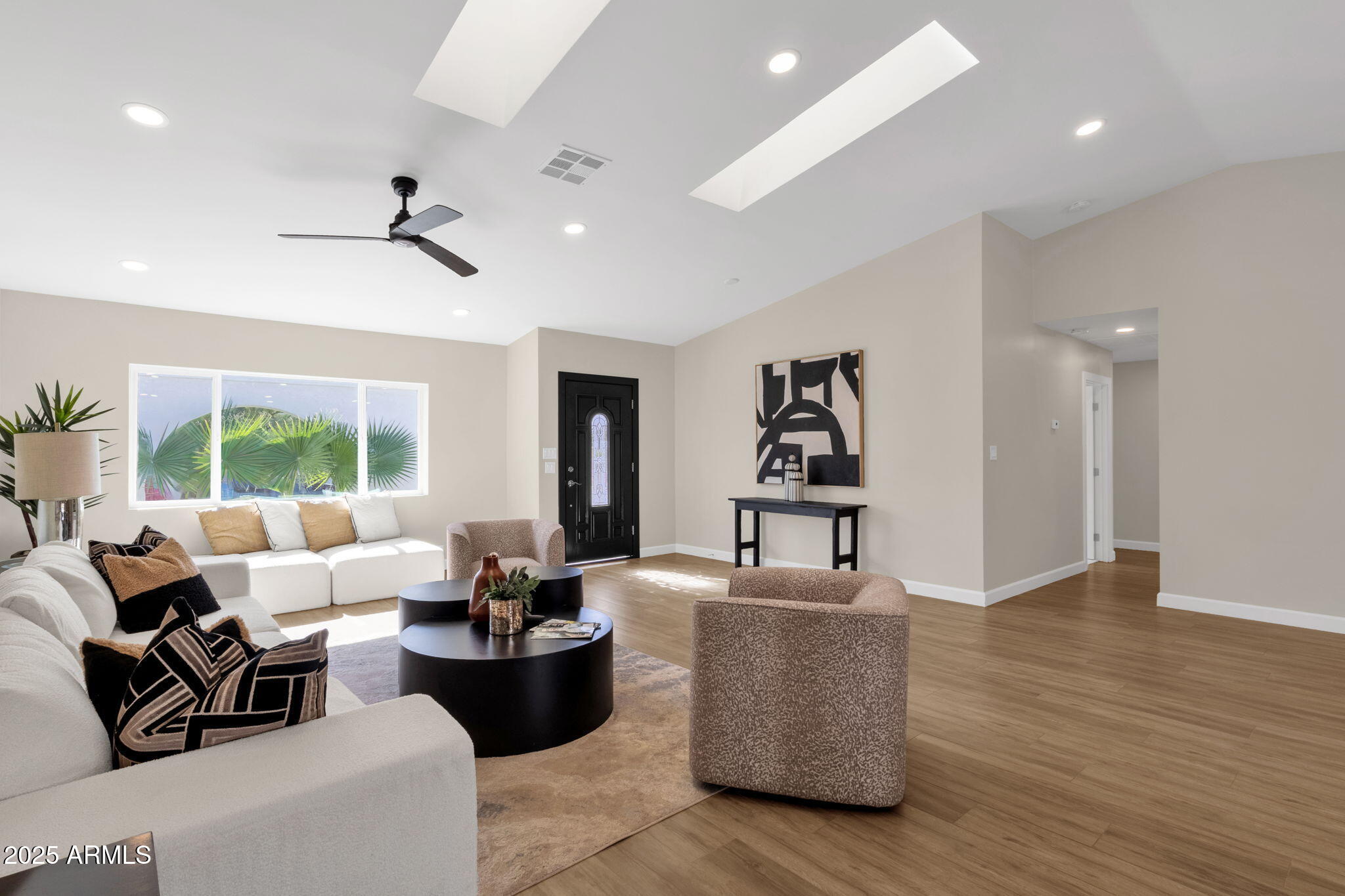 2276 East Mercer Lane Phoenix, AZ 85028 - Photo 16 of 61 a living room with couches and kitchen view with wooden floor