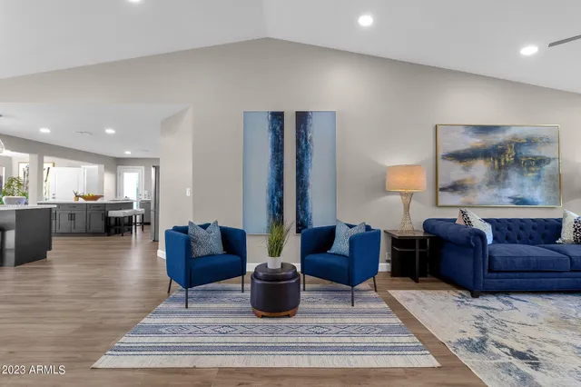 a kitchen with a table chairs sink and wooden floor