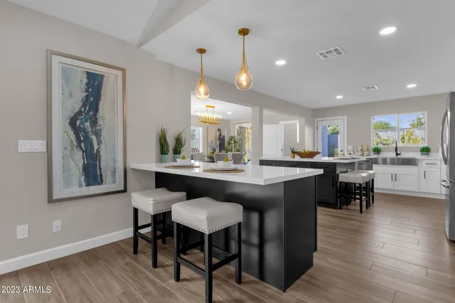 a view of a dining room with furniture a chandelier and wooden floor