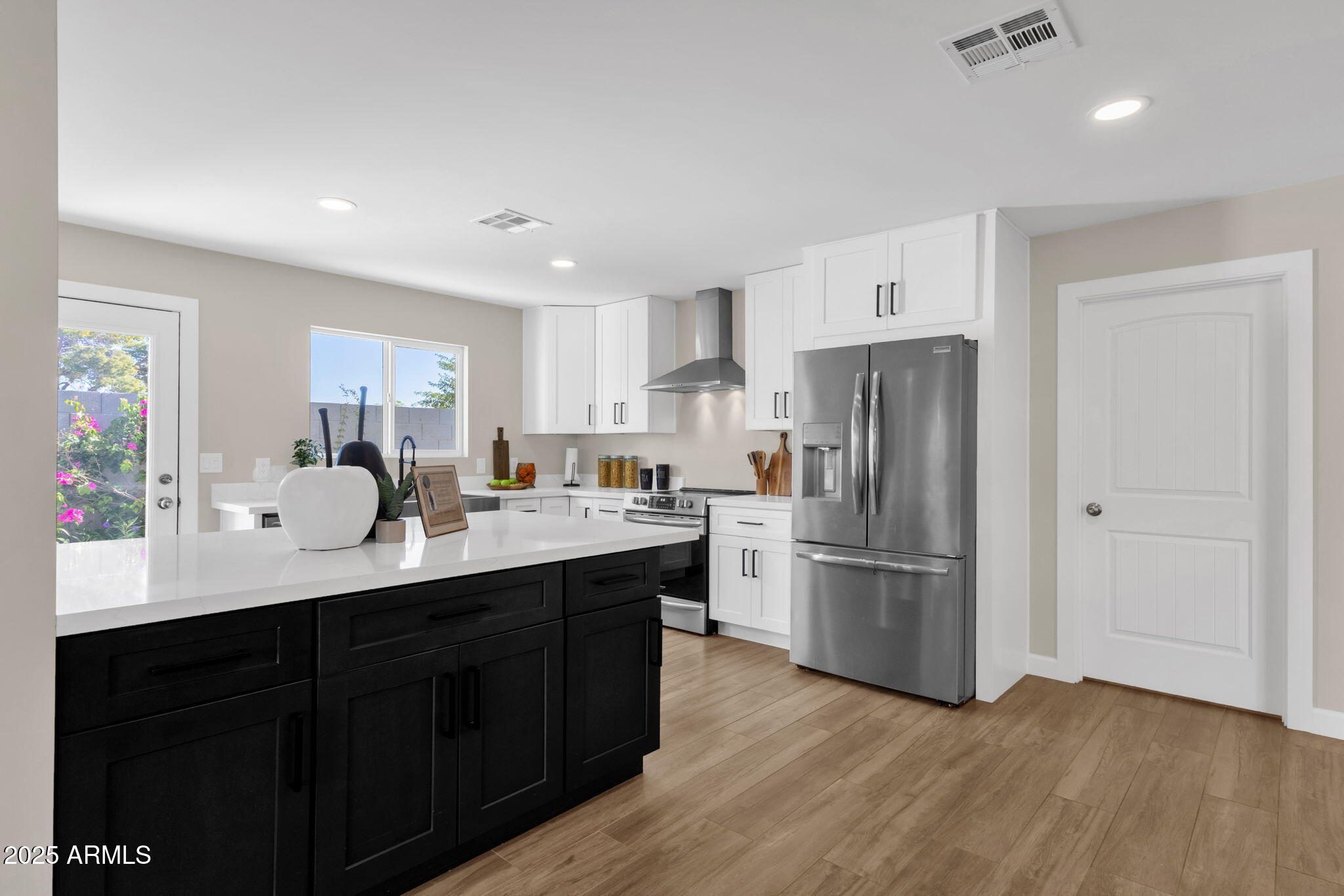 2276 East Mercer Lane Phoenix, AZ 85028 - Photo 27 of 61 a kitchen with stainless steel appliances a refrigerator sink and wooden cabinets