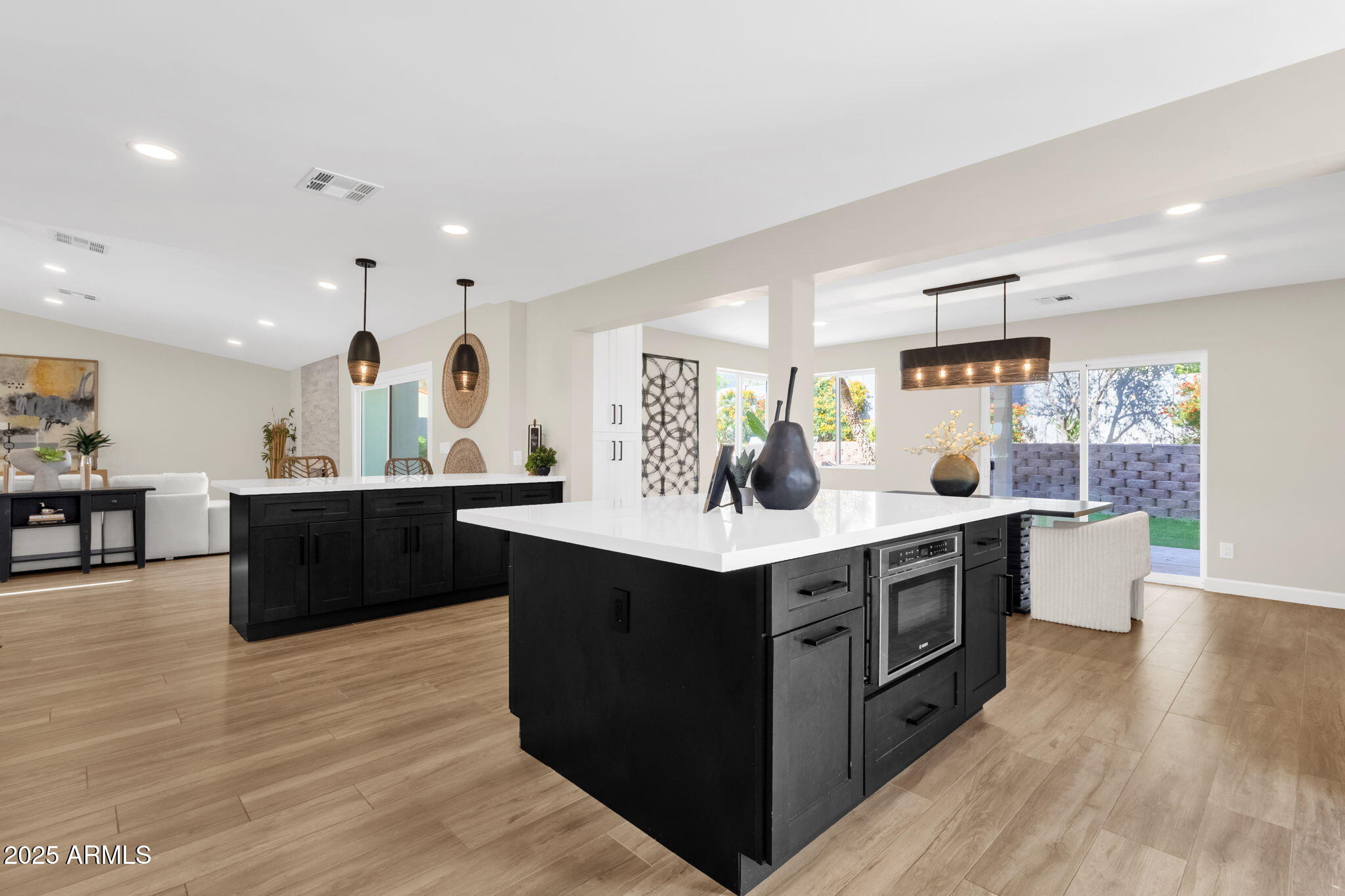 2276 East Mercer Lane Phoenix, AZ 85028 - Photo 30 of 61 a kitchen with stainless steel appliances kitchen island a cabinets and wooden floor