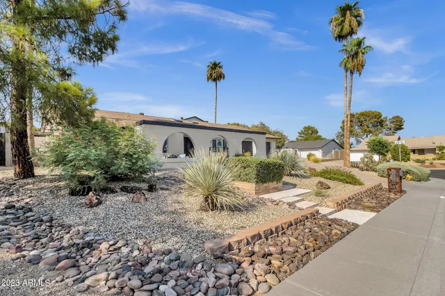 a front view of a house with a garden
