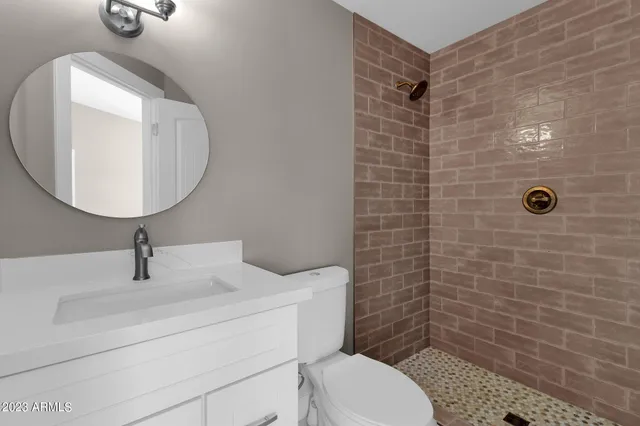 a bed room with a bed and a ceiling fan