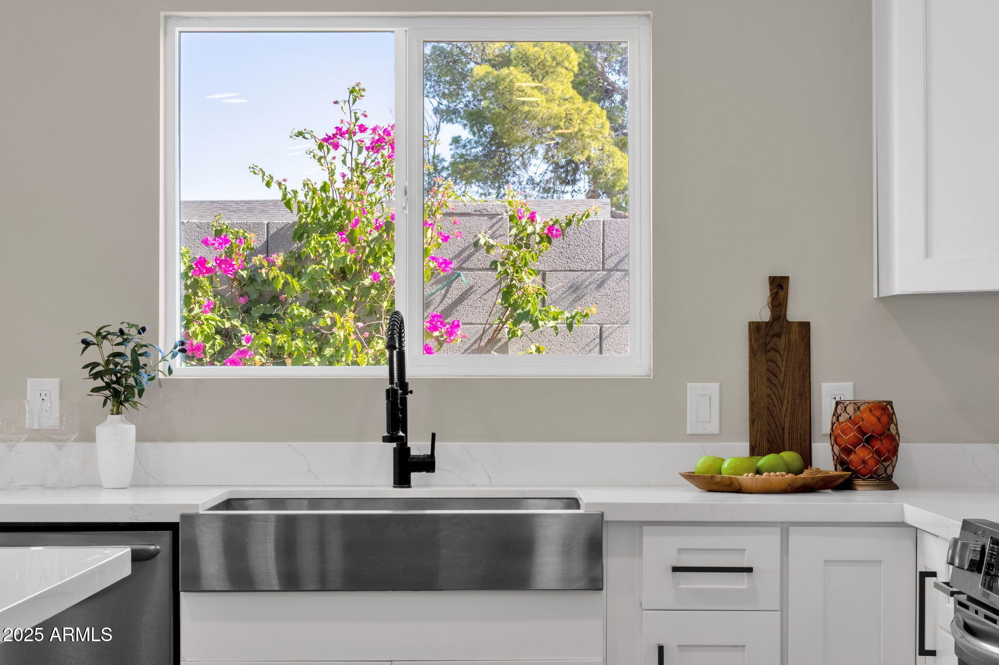 2276 East Mercer Lane Phoenix, AZ 85028 - Photo 32 of 61 a kitchen with a sink flowers and window