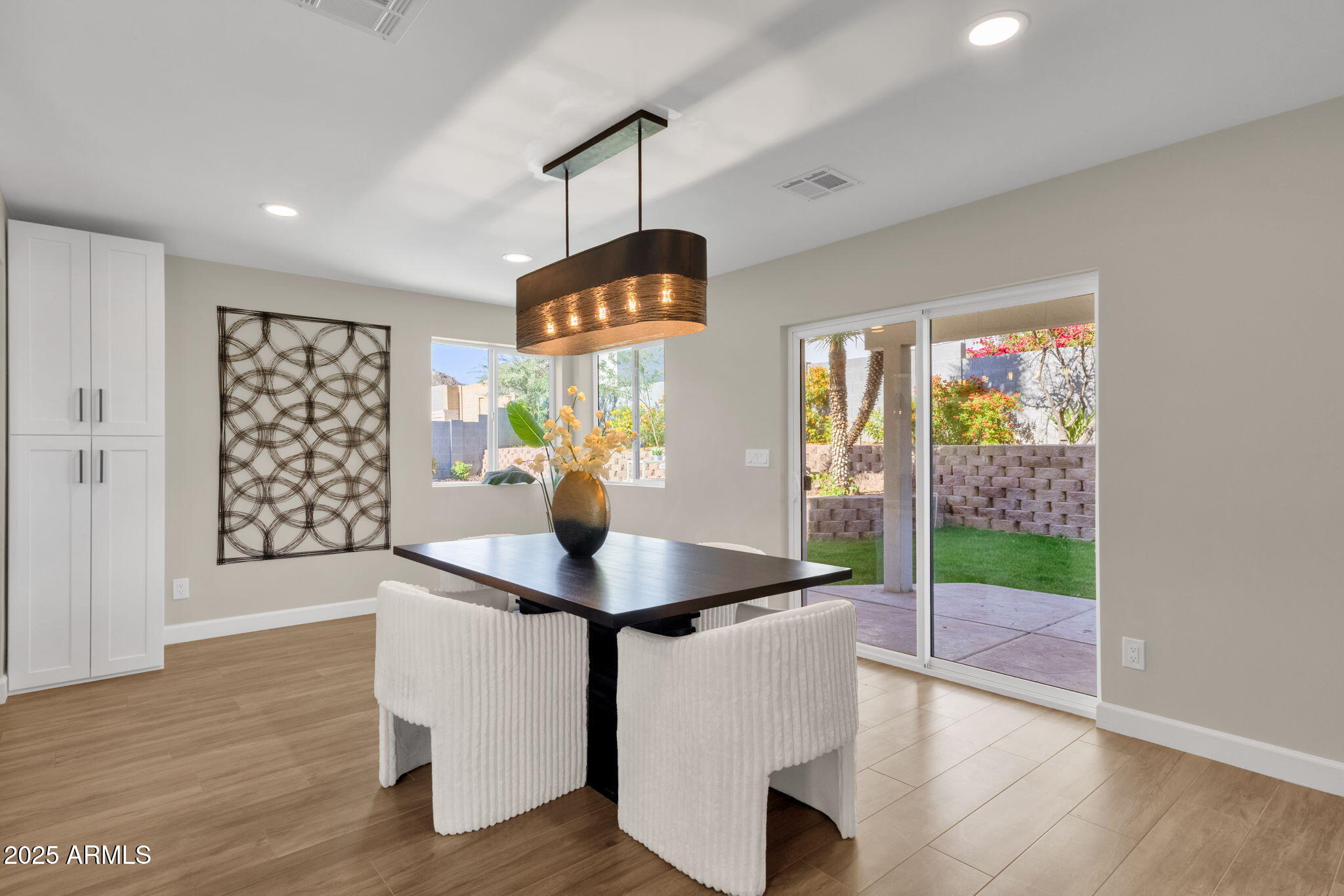 2276 East Mercer Lane Phoenix, AZ 85028 - Photo 33 of 61 a view of a dining room with furniture wooden floor and window