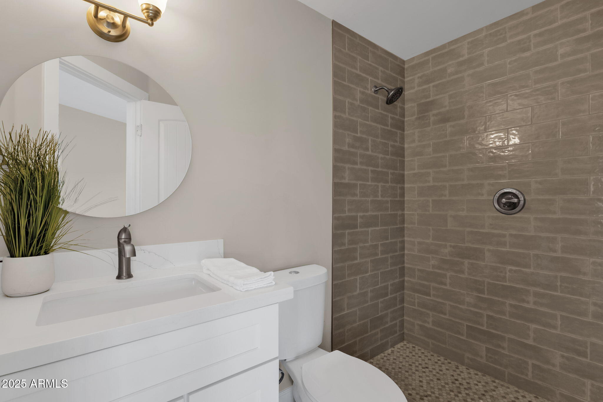 2276 East Mercer Lane Phoenix, AZ 85028 - Photo 39 of 61 a bathroom with a toilet sink and mirror