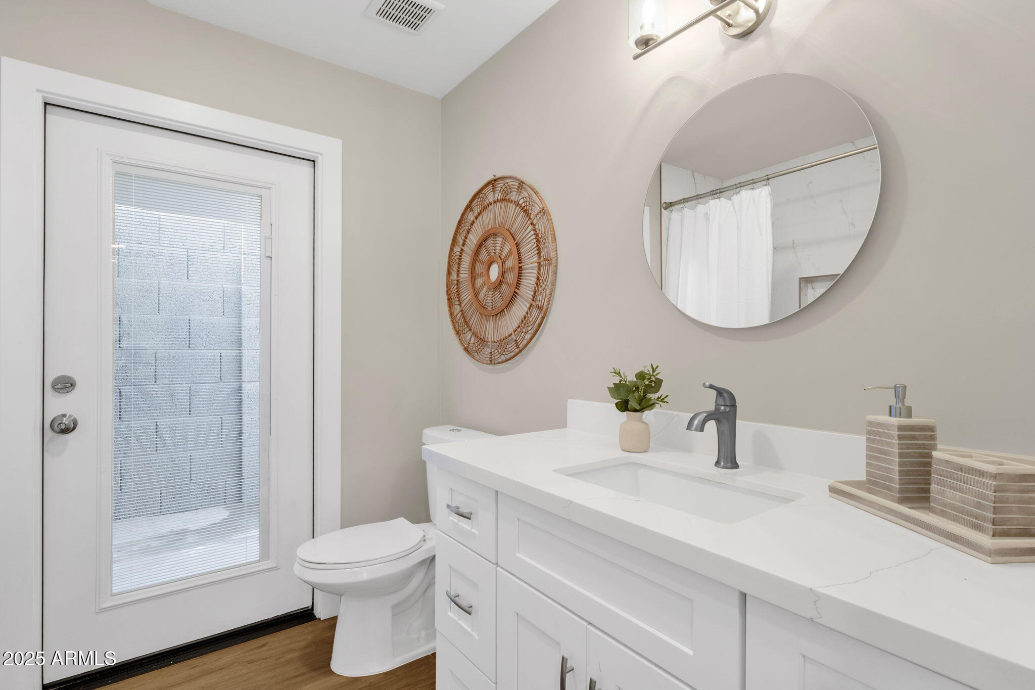 2276 East Mercer Lane Phoenix, AZ 85028 - Photo 43 of 61 a bathroom with a toilet a sink a mirror and shower