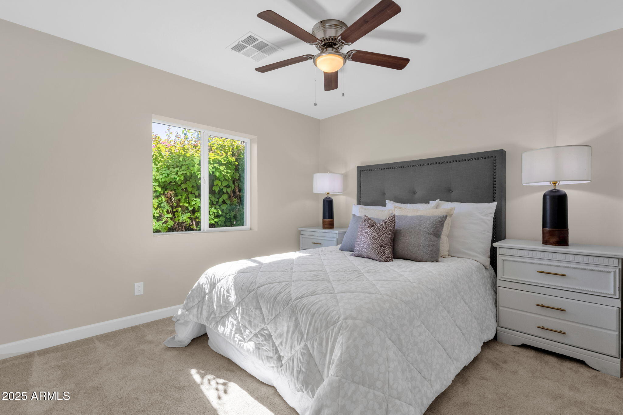 2276 East Mercer Lane Phoenix, AZ 85028 - Photo 45 of 61 a bedroom with a large bed and a window