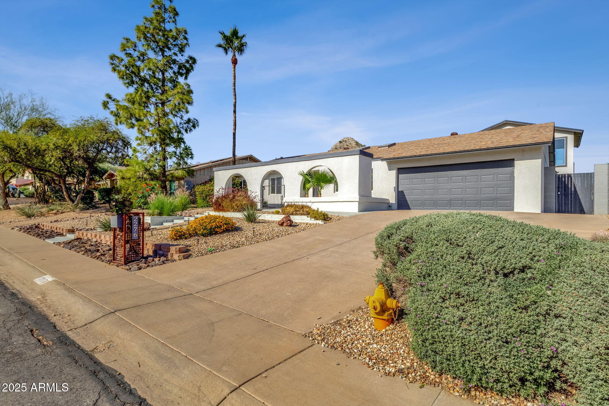 2276 East Mercer Lane Phoenix, AZ 85028 - Photo 7 of 61 a front view of a house with a yard