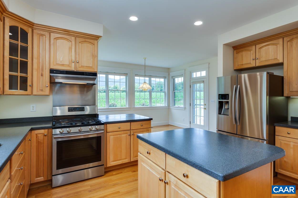 1904 Beaver Ridge Road Crozet, VA 22932 - Photo 22 of 70 a kitchen with granite countertop a stove and a refrigerator
