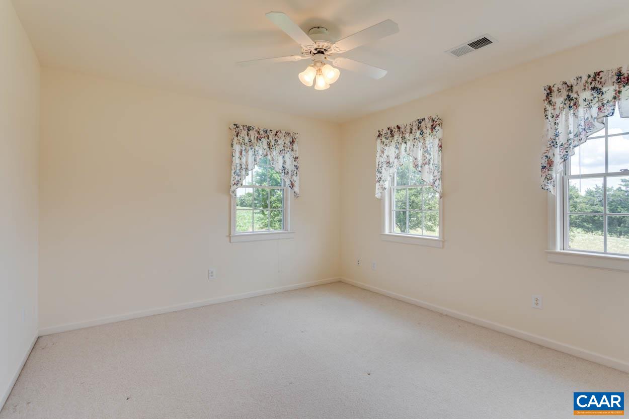 1904 Beaver Ridge Road Crozet, VA 22932 - Photo 36 of 70 an empty room with windows and ceiling fan