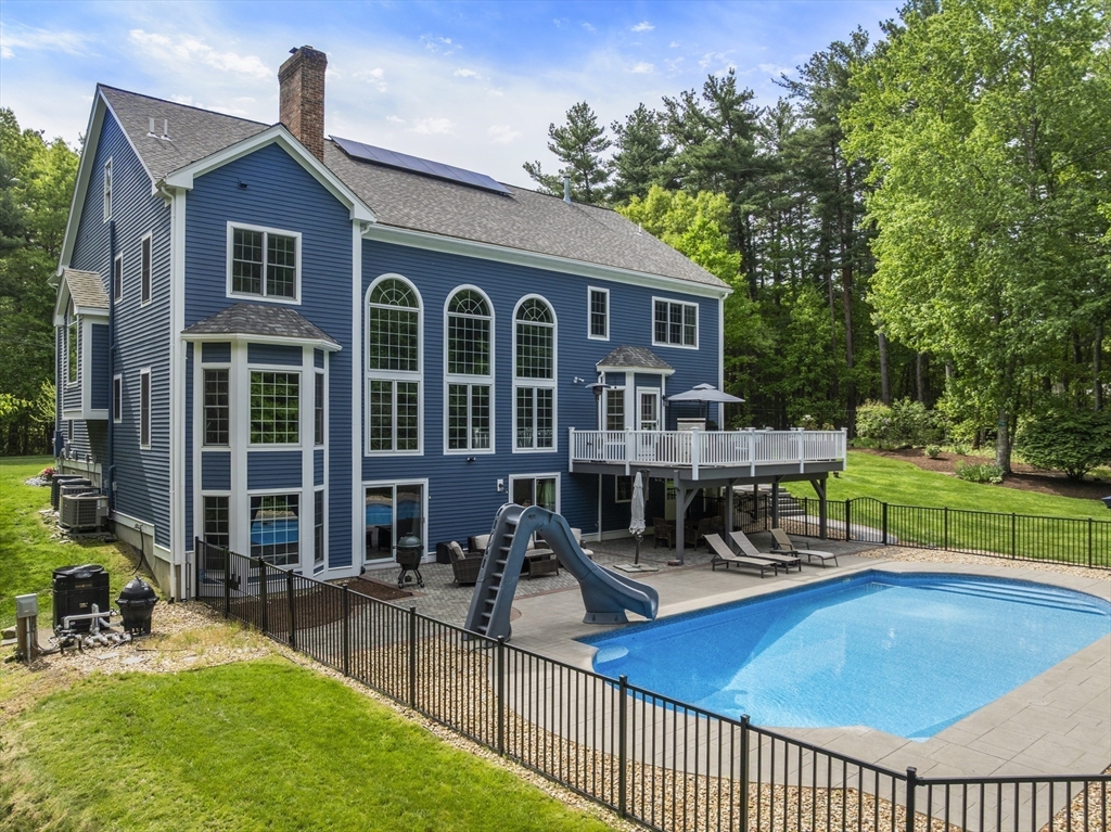 220 Newtown Road Acton, MA 01720 - Photo 32 of 39 a view of a house with sitting area and garden