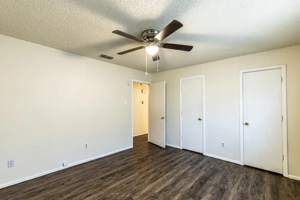 a view of a livingroom with a ceiling fan and wooden floor