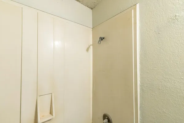 a bathroom with a glass shower door