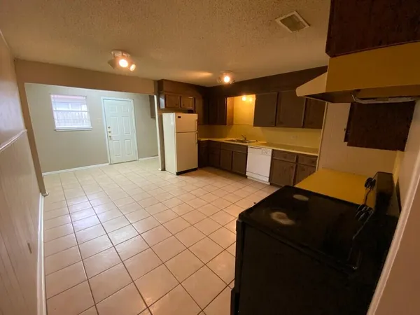 a kitchen with a sink and a refrigerator