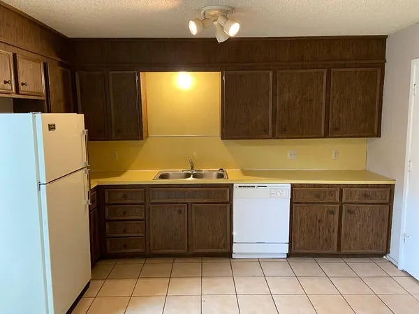 a kitchen with a refrigerator and cabinets