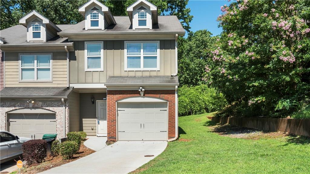 2909 Hillside Place, Unit 35 Decatur, GA 30034 - Photo 1 of 1 a front view of a house with garden
