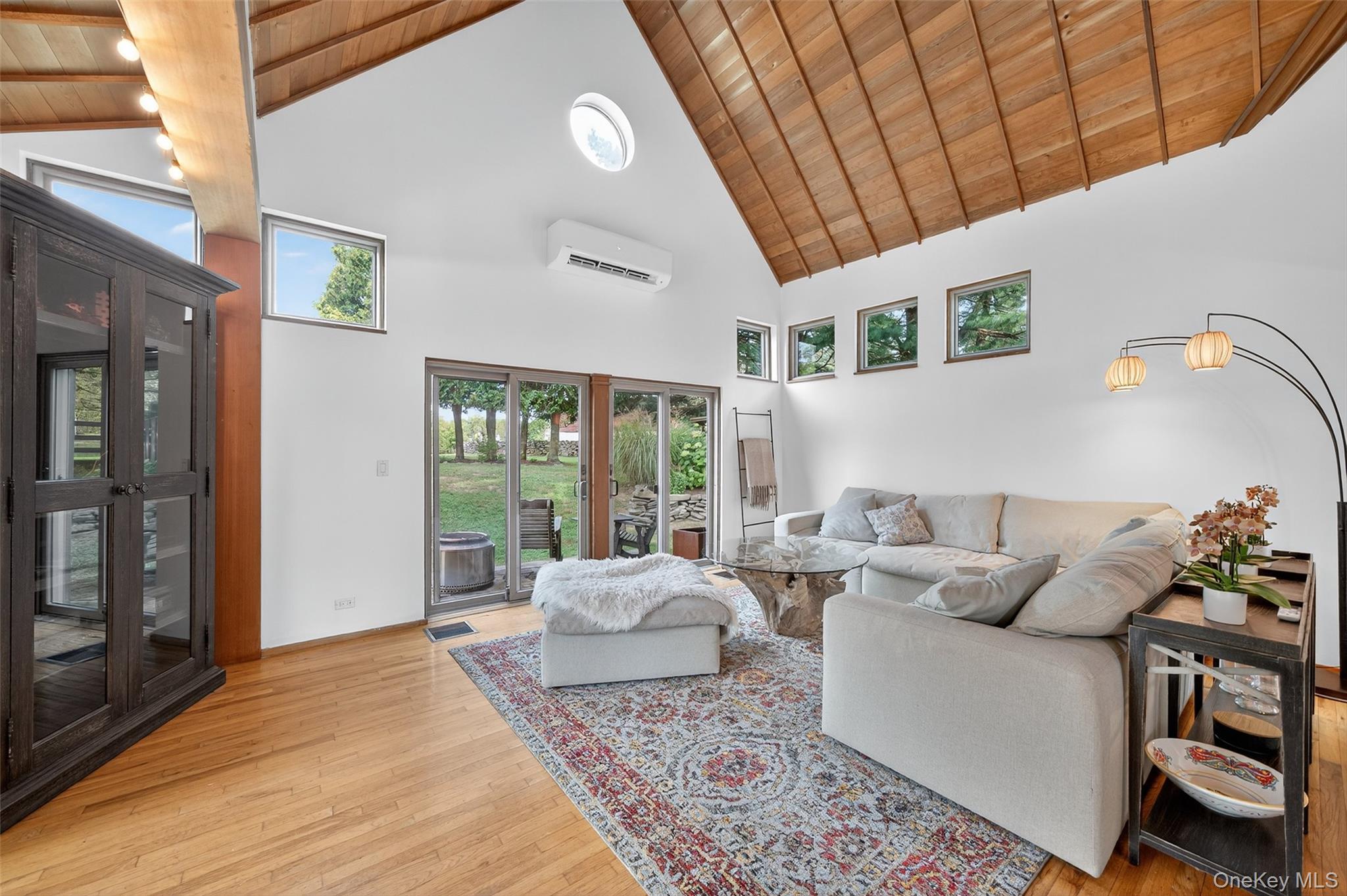 441 Scotchtown Collabar Road Middletown, NY 10941 - Photo 22 of 48 Living room with high vaulted ceiling, healthy amount of natural light, wood ceiling, light wood-style floors, and a wall mounted AC