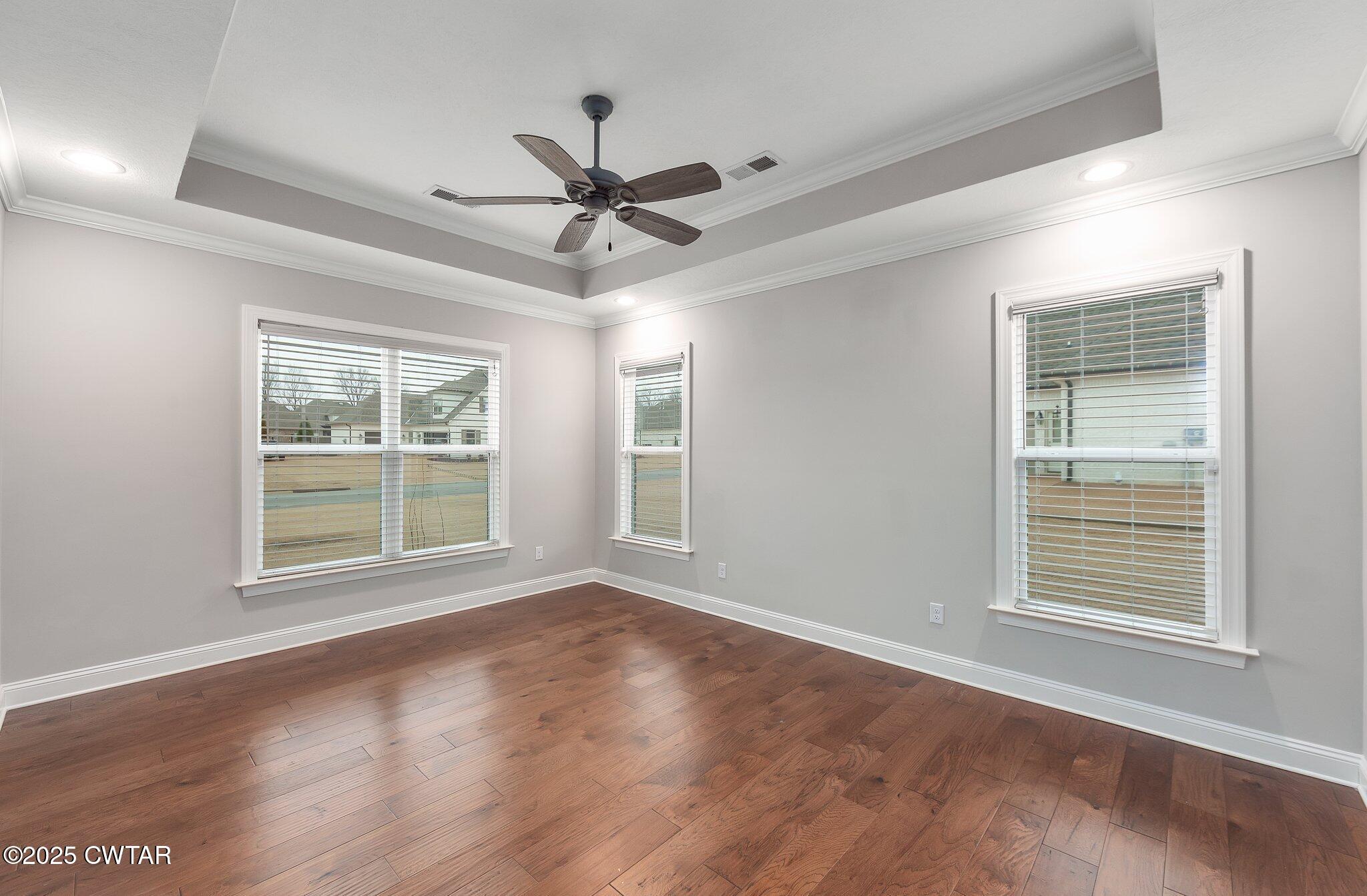 42 Lancaster Cove Jackson, TN 38305 - Photo 19 of 44 a view of an empty room with a window and wooden floor