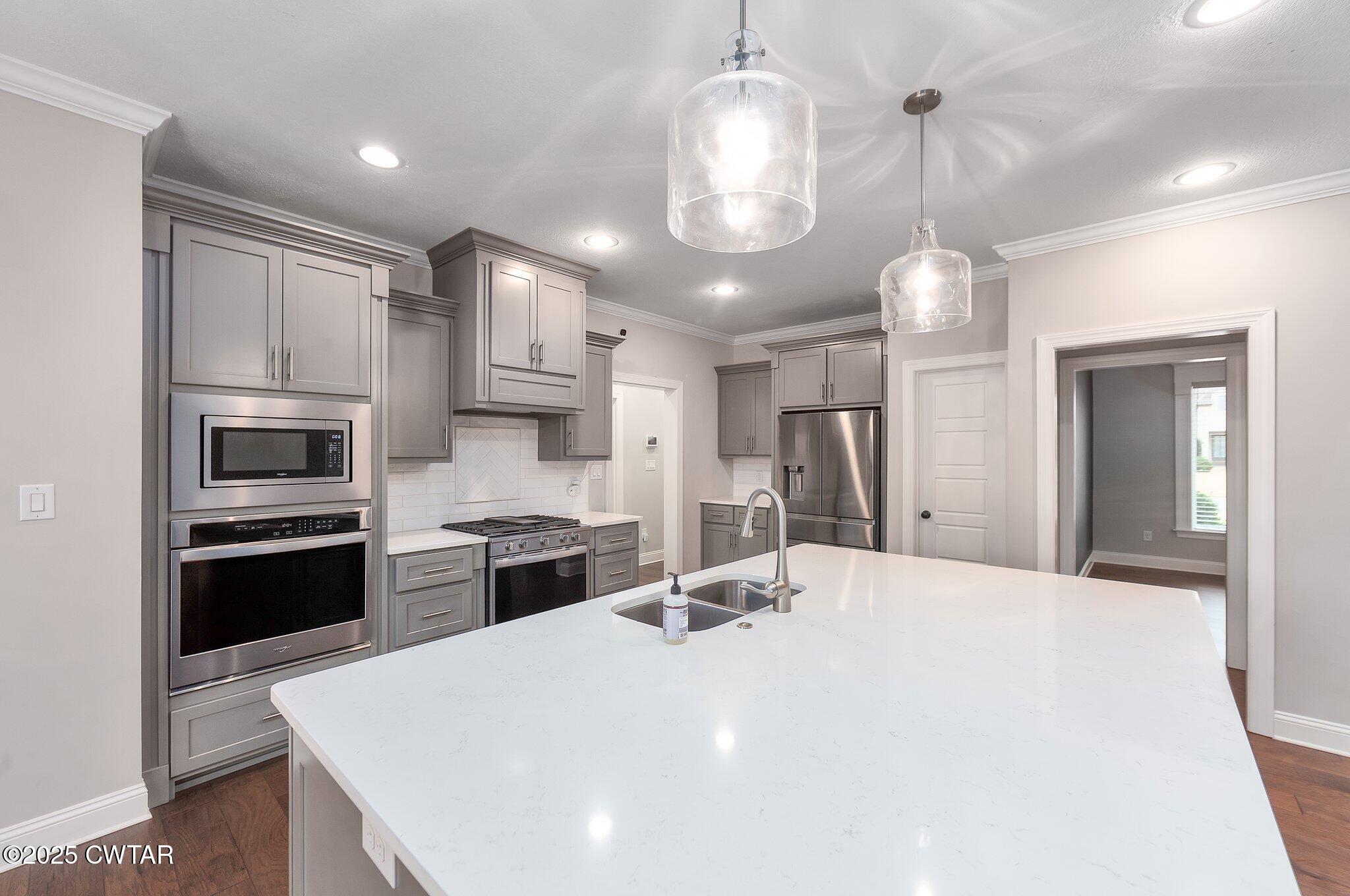 42 Lancaster Cove Jackson, TN 38305 - Photo 25 of 44 a large kitchen with a sink stainless steel appliances and chandelier