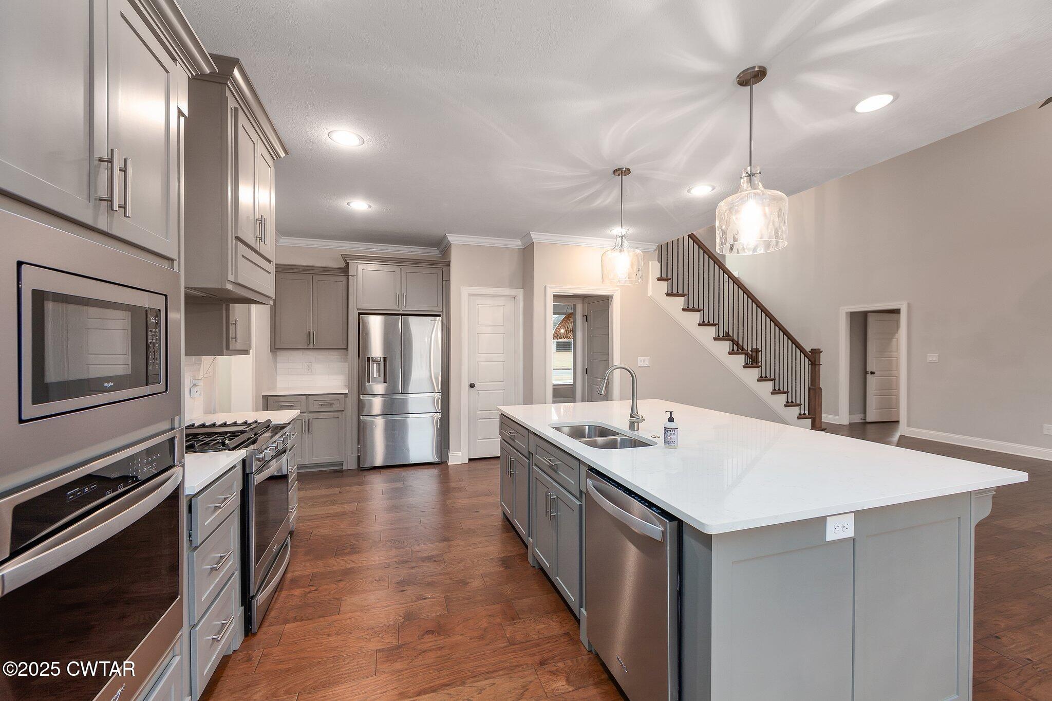 42 Lancaster Cove Jackson, TN 38305 - Photo 26 of 44 a kitchen with stainless steel appliances granite countertop a sink a stove and a refrigerator