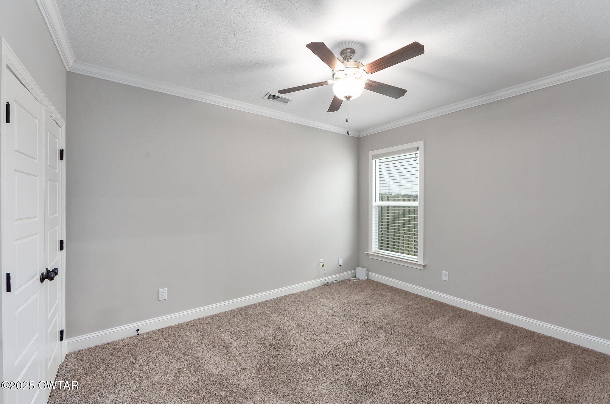 42 Lancaster Cove Jackson, TN 38305 - Photo 30 of 44 an empty room with windows and fan