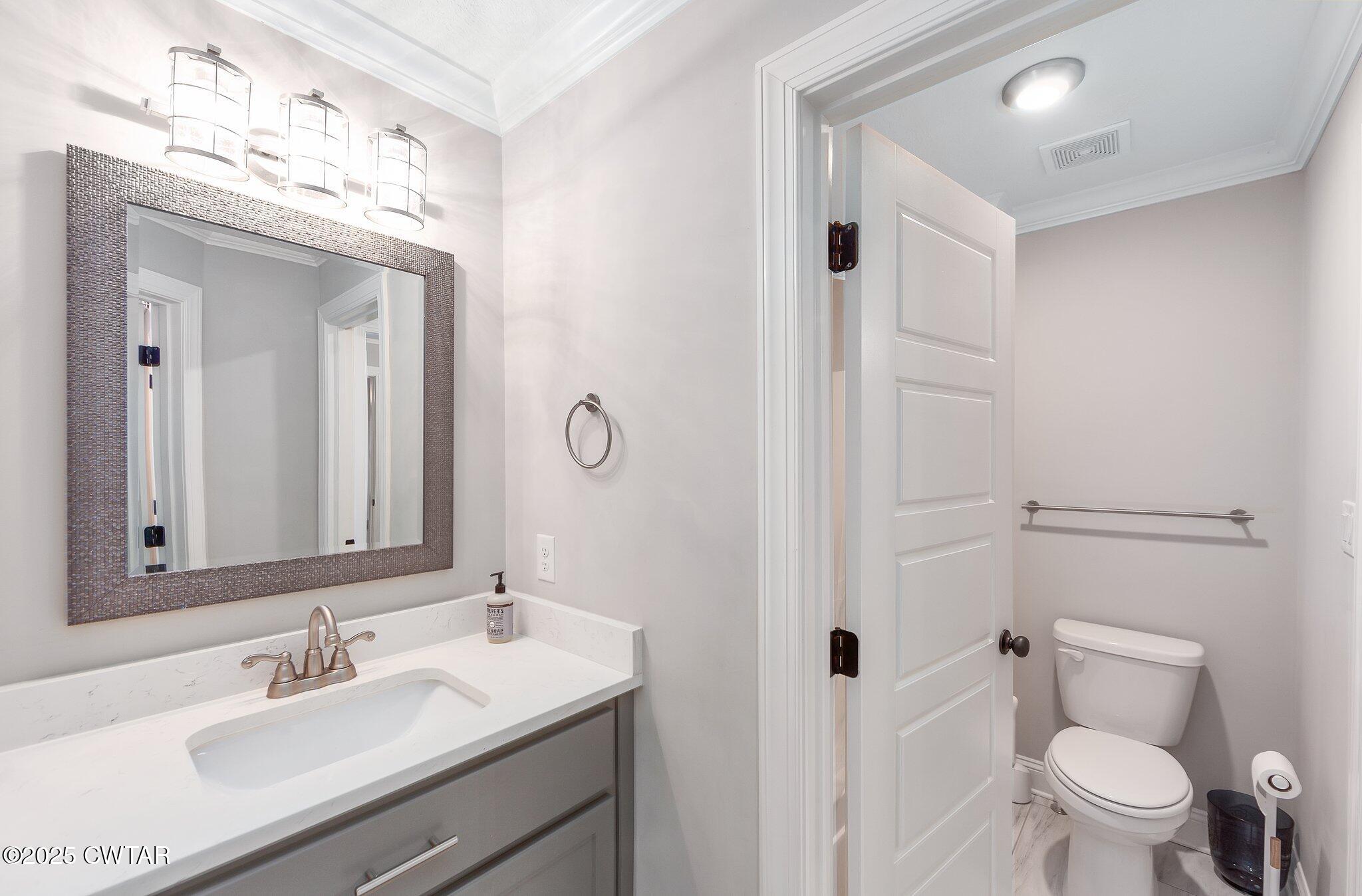 42 Lancaster Cove Jackson, TN 38305 - Photo 37 of 44 a bathroom with a sink vanity mirror and toilet