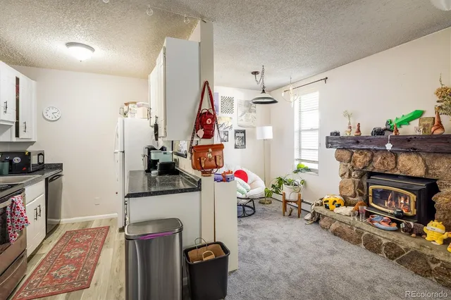 a view of a livingroom with furniture and a fireplace