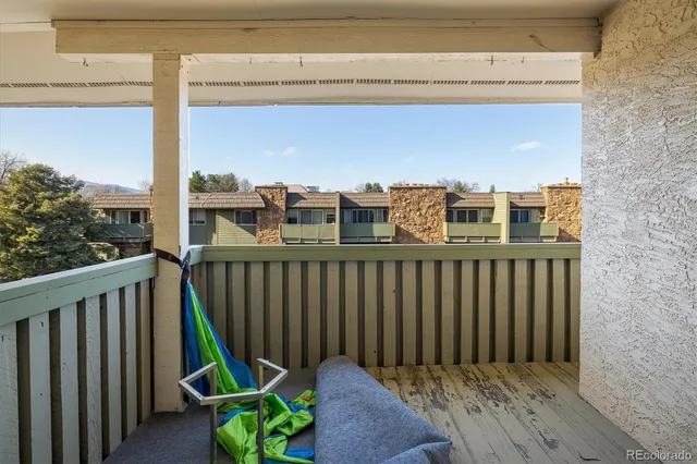 a view of a balcony with wooden fence
